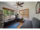 Bright bedroom with hardwood floors, large windows, and a comfortable futon at 216 W South Ave, Tampa, FL 33603