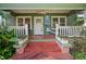 Inviting front porch with string lights, fan, and charming decorative plants at 216 W South Ave, Tampa, FL 33603