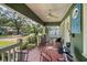 Cozy covered front porch with ceiling fan, comfortable seating, and neighborhood views at 216 W South Ave, Tampa, FL 33603