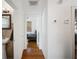 Hallway with hardwood flooring and view into bathroom and bedroom at 216 W South Ave, Tampa, FL 33603