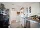 Efficient kitchen with white cabinets, stainless steel appliances, and modern flooring, providing a practical cooking space at 216 W South Ave, Tampa, FL 33603