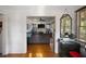 View from hallway into a living room featuring hardwood floors, a fireplace, and neutral decor, creating a welcoming space at 216 W South Ave, Tampa, FL 33603
