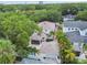 Aerial view showcasing home with screened in lanai, pool and tropical landscaping at 2522 W Watrous Ave, Tampa, FL 33629