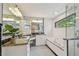 Bright bathroom featuring dual sinks, granite counters, tub, and glass shower at 2522 W Watrous Ave, Tampa, FL 33629