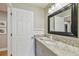 Bathroom with granite counters and updated fixtures at 2522 W Watrous Ave, Tampa, FL 33629