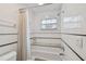 Bathroom with white tile, a shower/tub combo, and a granite shelf at 2522 W Watrous Ave, Tampa, FL 33629