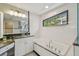Bright bathroom featuring granite counters, tub, and separate shower at 2522 W Watrous Ave, Tampa, FL 33629
