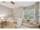 Bright bedroom with cozy window seat and charming butterfly decor, creating a warm, inviting space at 2522 W Watrous Ave, Tampa, FL 33629