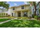 Inviting two-story home with well-maintained lawn, charming front porch, and lush landscaping at 2522 W Watrous Ave, Tampa, FL 33629