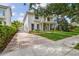 Charming home with manicured lawn, brick driveway, gated entrance, and mature trees for privacy at 2522 W Watrous Ave, Tampa, FL 33629