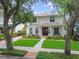 Beautiful two-story home with lush landscaping, a bench, and a charming front entrance at 2522 W Watrous Ave, Tampa, FL 33629