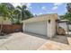 Spacious two-car garage with adjacent BBQ area and lush landscaping at 2522 W Watrous Ave, Tampa, FL 33629