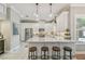 Bright kitchen featuring a large island with seating, granite countertops, stainless steel appliances, and custom cabinetry at 2522 W Watrous Ave, Tampa, FL 33629