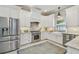Modern kitchen with stainless steel appliances, white cabinets, and farmhouse sink at 2522 W Watrous Ave, Tampa, FL 33629