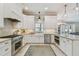 Bright kitchen features white cabinets, stainless steel appliances and a large farmhouse sink at 2522 W Watrous Ave, Tampa, FL 33629