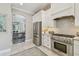 This kitchen features stainless steel appliances, white cabinets, and tile backsplash at 2522 W Watrous Ave, Tampa, FL 33629