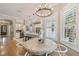 Eat-in kitchen featuring a round table, kitchen island with seating and white cabinets at 2522 W Watrous Ave, Tampa, FL 33629