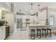 Well-lit kitchen with white cabinets, stainless steel appliances, a wine cooler, and a large island at 2522 W Watrous Ave, Tampa, FL 33629