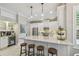 Bright kitchen with white cabinetry, stainless steel appliances, a center island, and bar stool seating at 2522 W Watrous Ave, Tampa, FL 33629