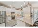 Bright kitchen with white cabinets, stainless steel appliances, granite countertops and stylish pendant lighting at 2522 W Watrous Ave, Tampa, FL 33629
