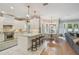 Open kitchen with a large island, granite countertops, stainless steel appliances, and bar stool seating at 2522 W Watrous Ave, Tampa, FL 33629
