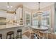 Open kitchen with white cabinets, stainless steel appliances, granite countertop island, and breakfast table at 2522 W Watrous Ave, Tampa, FL 33629