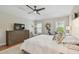 Main bedroom with hardwood floors, ceiling fan, dresser, and windows at 2522 W Watrous Ave, Tampa, FL 33629
