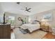 Bright main bedroom with windows, hardwood floors, ceiling fan and neutral decor at 2522 W Watrous Ave, Tampa, FL 33629