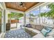 Relaxing screened-in patio with comfortable seating, stylish rug and tropical views at 2522 W Watrous Ave, Tampa, FL 33629
