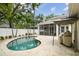 Private backyard pool with travertine tile deck, tropical landscaping, and screened lanai offers the perfect outdoor retreat at 2522 W Watrous Ave, Tampa, FL 33629