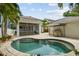Private backyard oasis with a kidney-shaped pool, screened-in lanai, and outdoor grilling area at 2522 W Watrous Ave, Tampa, FL 33629