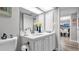 Bright bathroom with vanity, stylish sink, and well-lit mirror, with a view to dining room at 2616 Cove Cay Dr # 505, Clearwater, FL 33760