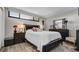 Bedroom featuring dark wood furniture, light grey walls, and a bright window at 2616 Cove Cay Dr # 505, Clearwater, FL 33760