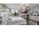 Bedroom featuring a large window with beautiful views, ceiling fan, TV, and comfortable furnishings at 2616 Cove Cay Dr # 505, Clearwater, FL 33760