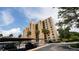 Multi-story exterior view of building with covered parking and palm tree landscaping at 2616 Cove Cay Dr # 505, Clearwater, FL 33760