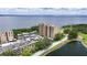 Picturesque condo building with serene water views, mature landscaping, and parking at 2616 Cove Cay Dr # 505, Clearwater, FL 33760