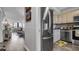 Open-concept kitchen flowing into the living area with wood floors and stainless refrigerator at 2616 Cove Cay Dr # 505, Clearwater, FL 33760