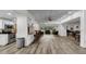 Spacious living room with hardwood floors, stainless steel appliances, and modern barstools at 2616 Cove Cay Dr # 505, Clearwater, FL 33760