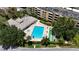 Community pool and shuffleboard court surrounded by mature trees and lush landscaping at 2616 Cove Cay Dr # 505, Clearwater, FL 33760