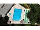 Community pool and shuffleboard court with lounge chairs and well-maintained landscaping at 2616 Cove Cay Dr # 505, Clearwater, FL 33760