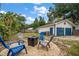 A cozy backyard featuring a seating area with firepit, detached garage, and lush landscaping at 310 N Lincoln Ave, Clearwater, FL 33755
