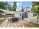 An outdoor patio features black metal chairs and table under a light canvas awning with a paver base at 310 N Lincoln Ave, Clearwater, FL 33755