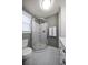 Bathroom features a shower with glass doors, hexagon tile floor, gray walls, and a white cabinet at 310 N Lincoln Ave, Clearwater, FL 33755