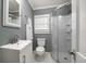 Updated bathroom with modern sink, toilet, glass shower, and a hexagonal tile floor at 310 N Lincoln Ave, Clearwater, FL 33755