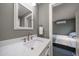 Bathroom showcasing a marble vanity and mirror, with a peek into an adjacent bedroom space at 310 N Lincoln Ave, Clearwater, FL 33755