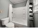 Bathroom featuring a toilet, tub and shower combination, and shelves at 310 N Lincoln Ave, Clearwater, FL 33755