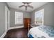 Bedroom featuring hardwood floors, a ceiling fan, two windows, and a vintage dresser at 310 N Lincoln Ave, Clearwater, FL 33755