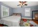 Bedroom featuring a ceiling fan, two windows, and a colorful floral rug at 310 N Lincoln Ave, Clearwater, FL 33755