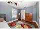Bedroom with hardwood floors, area rug, windows, chest of drawers, and a mirror at 310 N Lincoln Ave, Clearwater, FL 33755