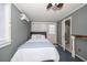 Cozy bedroom featuring a private bathroom, mini-split AC, and a ceiling fan at 310 N Lincoln Ave, Clearwater, FL 33755